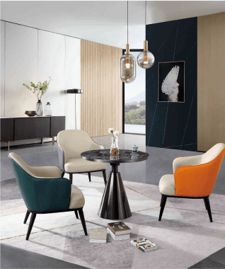 Modern room with a round black table, colorful chairs, and pendant lights. A sideboard holds vases, and a large nature photo adorns the wall, creating a calm vibe.