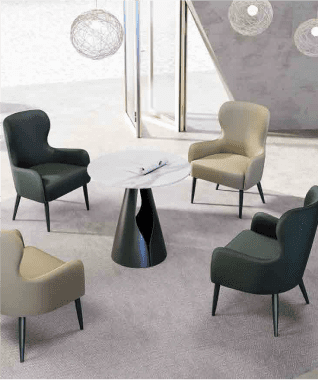 Modern seating area with a round table, surrounded by two black and two beige armchairs on a gray carpet. Stylish, minimalist decor creates a calm ambiance.