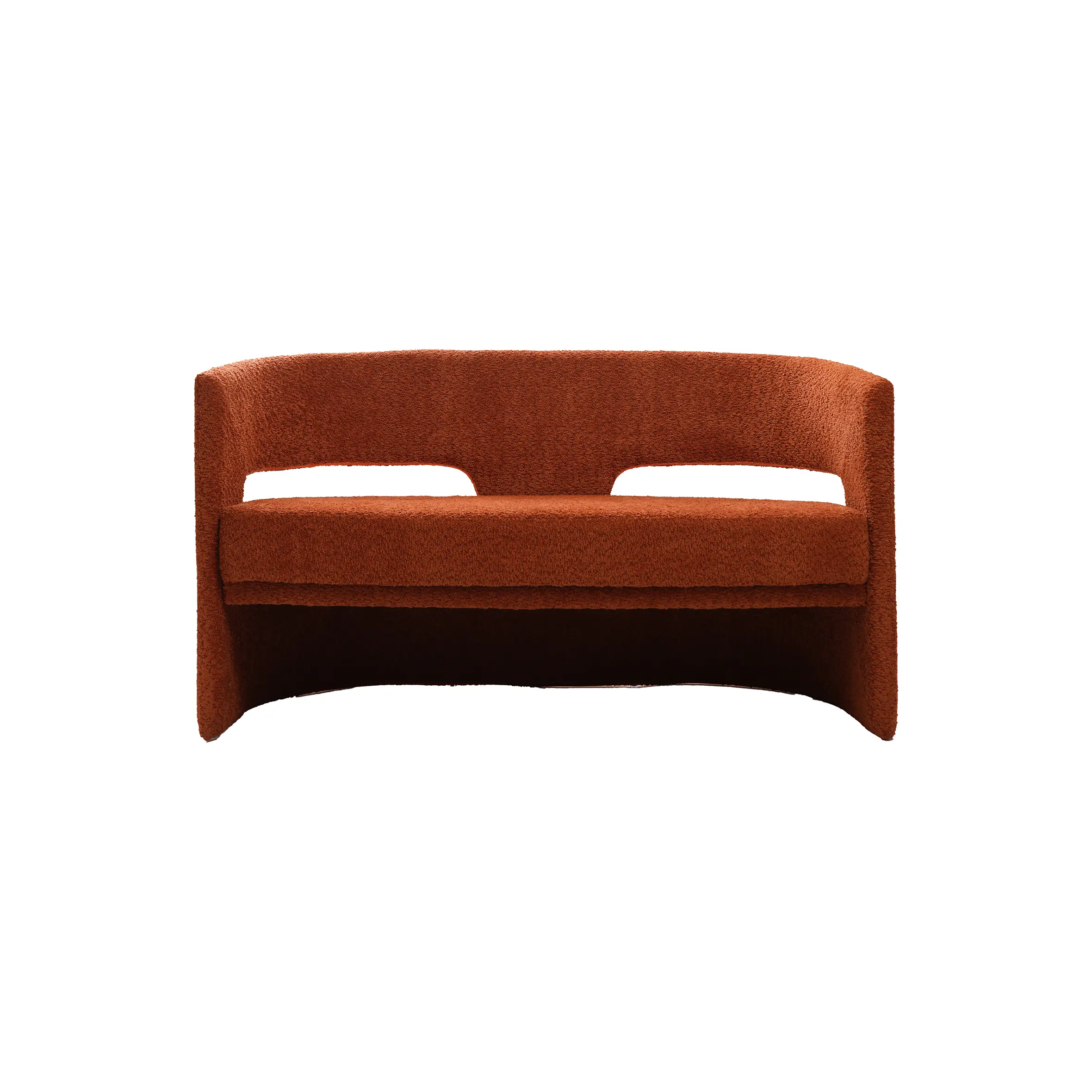 Modern interior with a sleek marble reception desk on the left, a round black side table, and a rust-colored sofa on the right. Minimalist and calm.