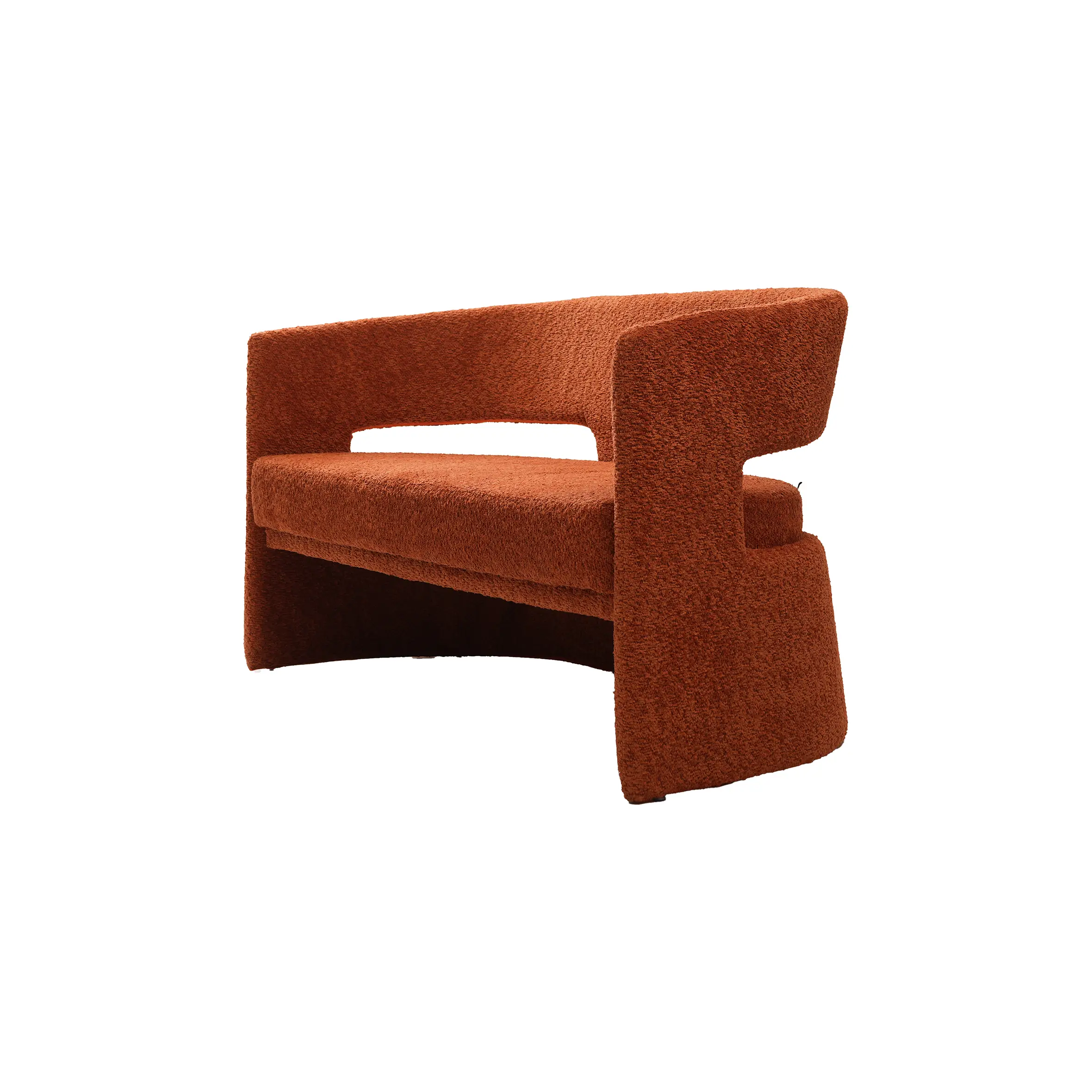 Modern interior with a sleek marble reception desk on the left, a round black side table, and a rust-colored sofa on the right. Minimalist and calm.