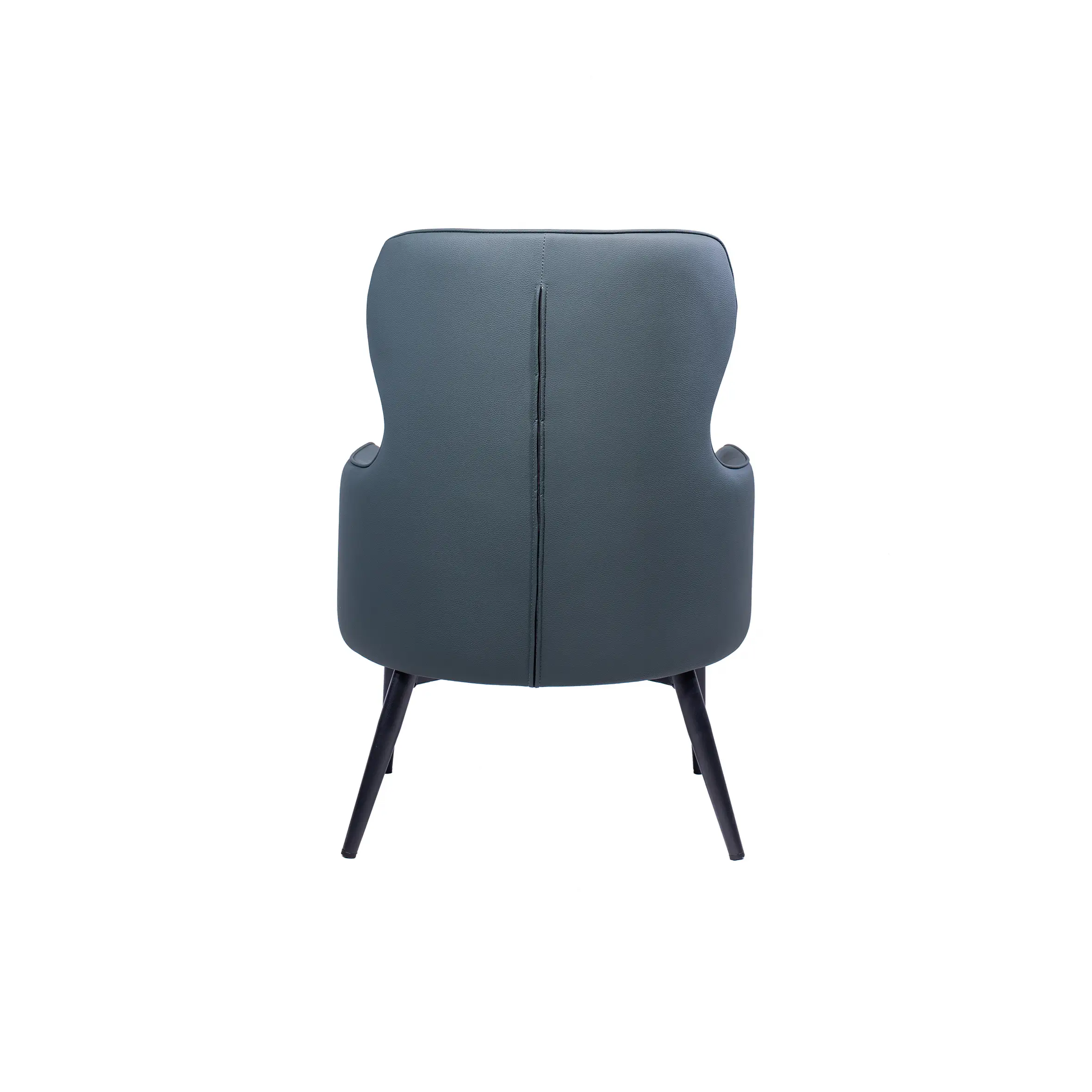 Modern office space with two dark gray armchairs facing a round black table. Background features white desks and office chairs near large windows.