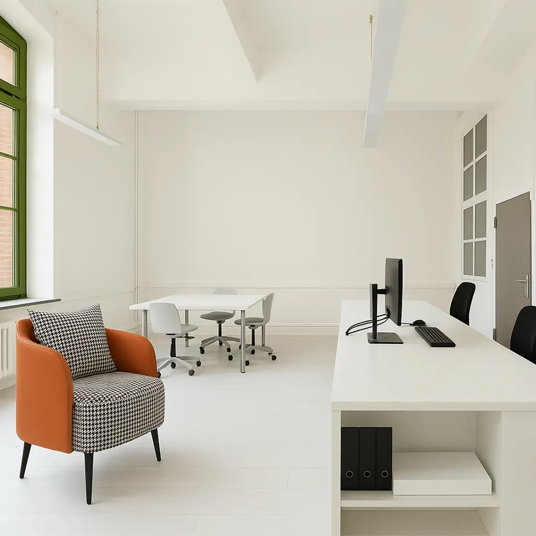 Minimalist office with a white desk, computer, black chair, and black binders. Orange and houndstooth armchair adds a pop of color, exuding modern elegance.