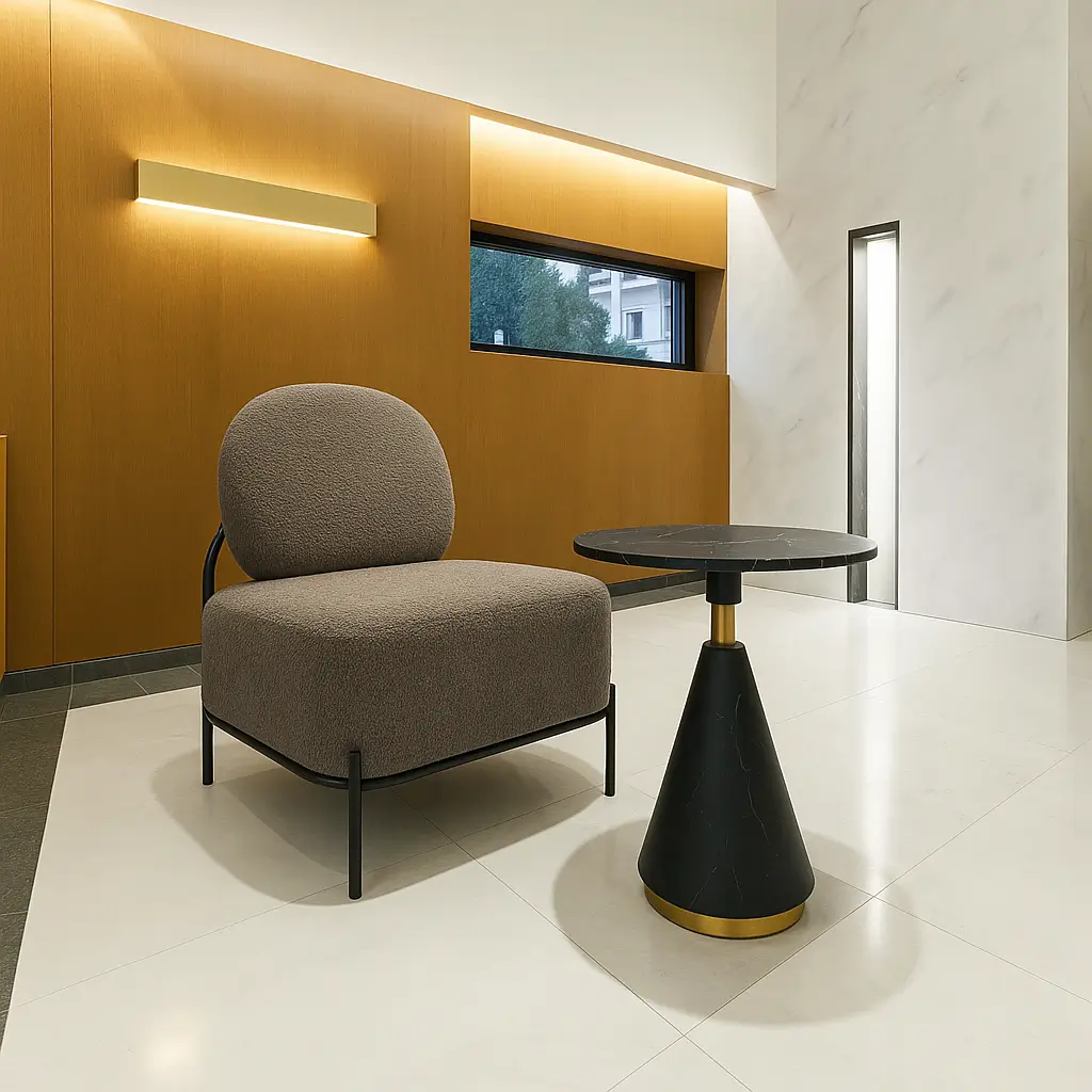 Modern lounge scene with a brown cushioned sofa beside a sleek, black marble-topped table on a light tile floor. Warm wood paneling adds coziness.