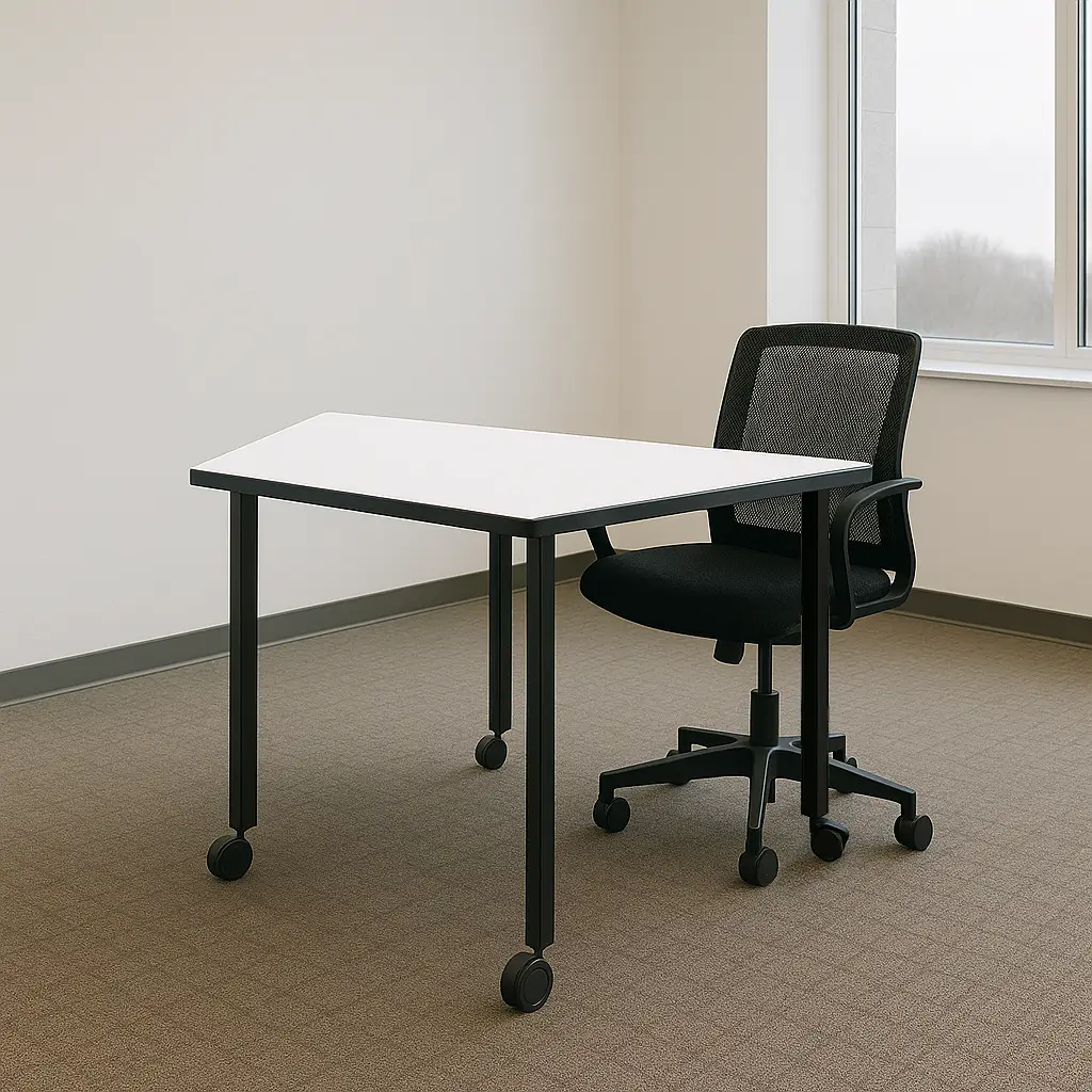 Modern office setting with a trapezoidal white desk and a black mesh swivel chair on wheels. Neutral tones and a bright window create a minimalist, professional vibe.