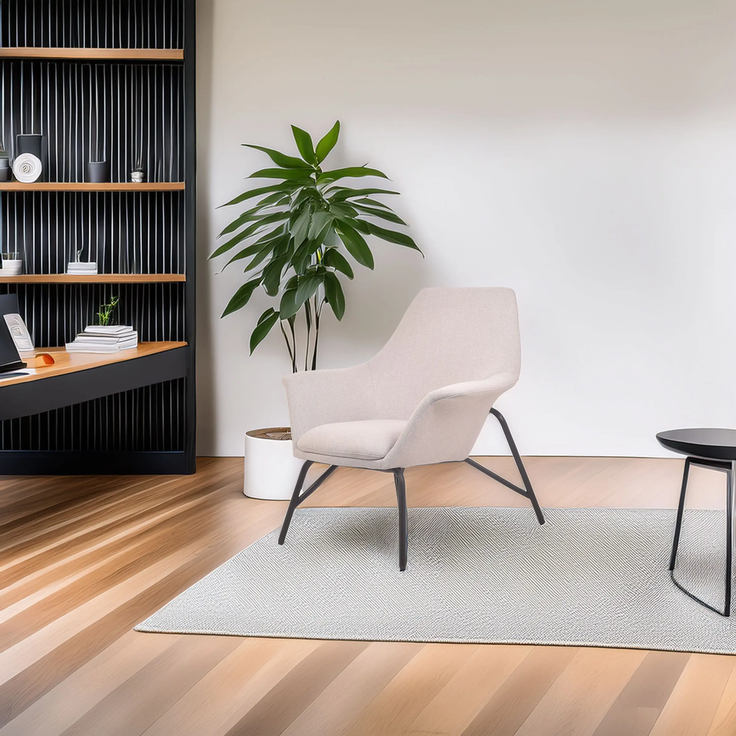 Modern interior with a beige armchair on a light rug, beside a potted plant. Shelving in the background holds books and decor, creating a calm atmosphere.