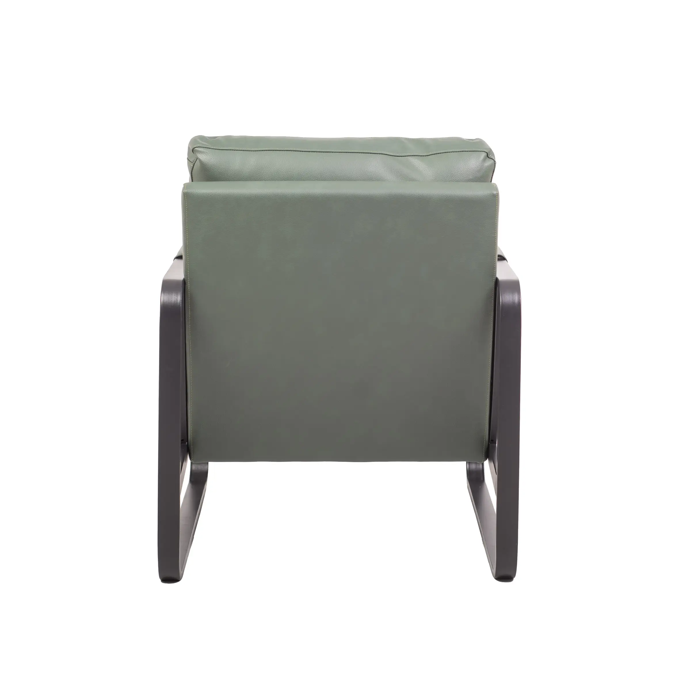 Modern living room with a green armchair on a geometric rug, surrounded by a tall floor lamp, potted plant, and a tall bookshelf filled with books.