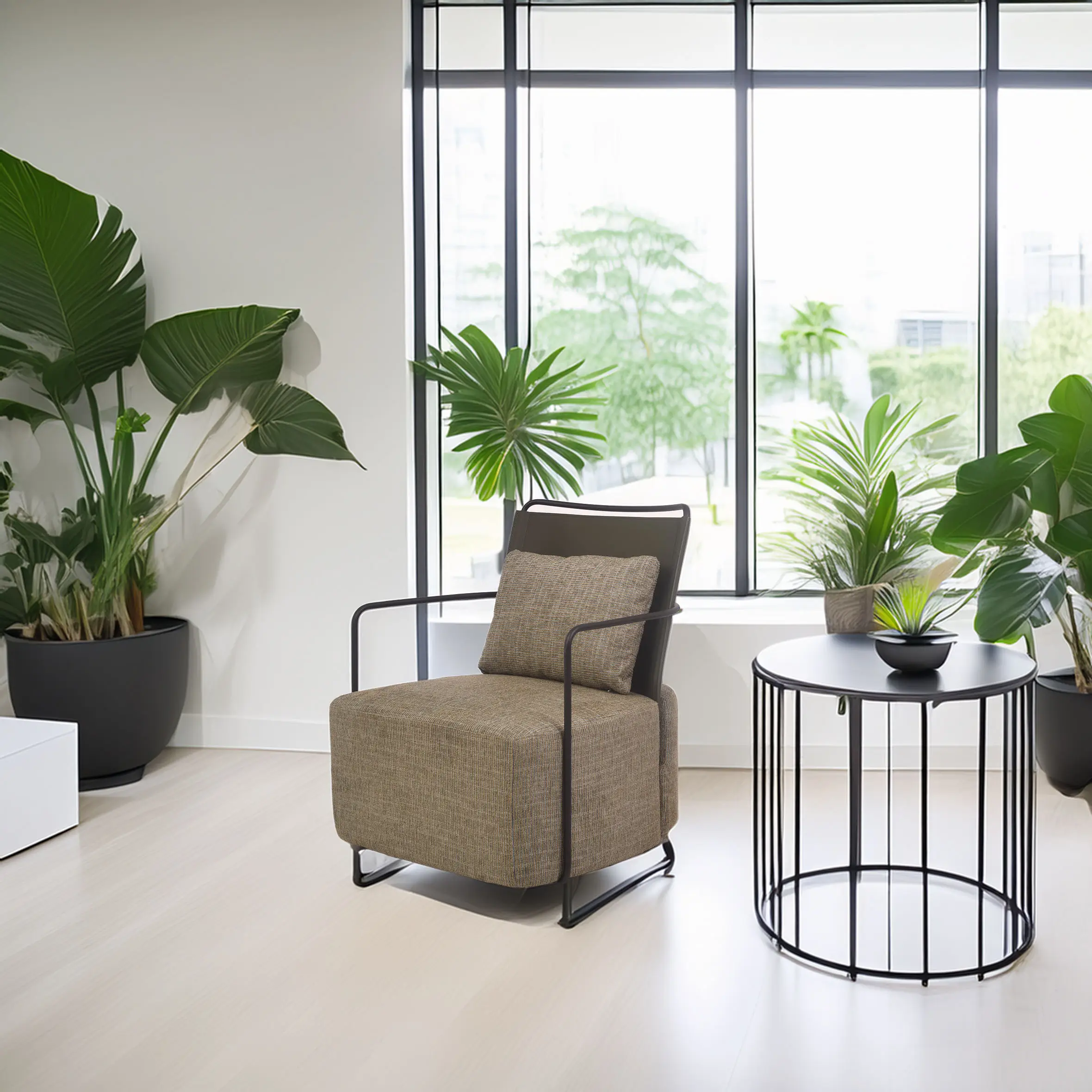 Modern room with large windows, featuring a green chair, a round black metal table with a small plant, and lush green potted plants, creating a fresh ambiance.
