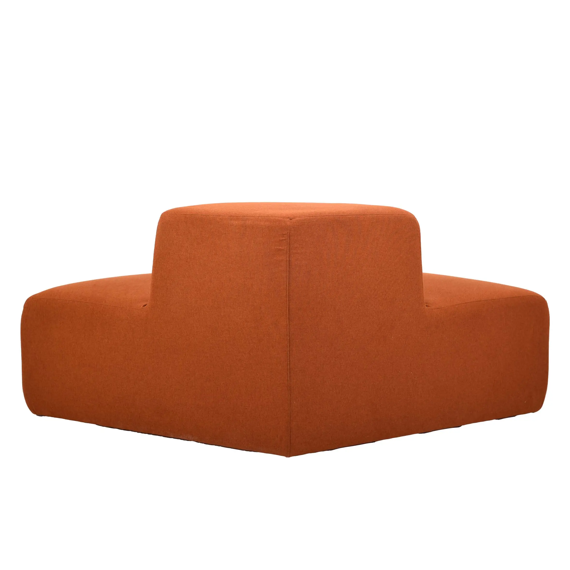 Spacious modern office with large windows, lush green plants, and wooden ceilings. Features a curved orange sofa and wood desks with gray chairs.