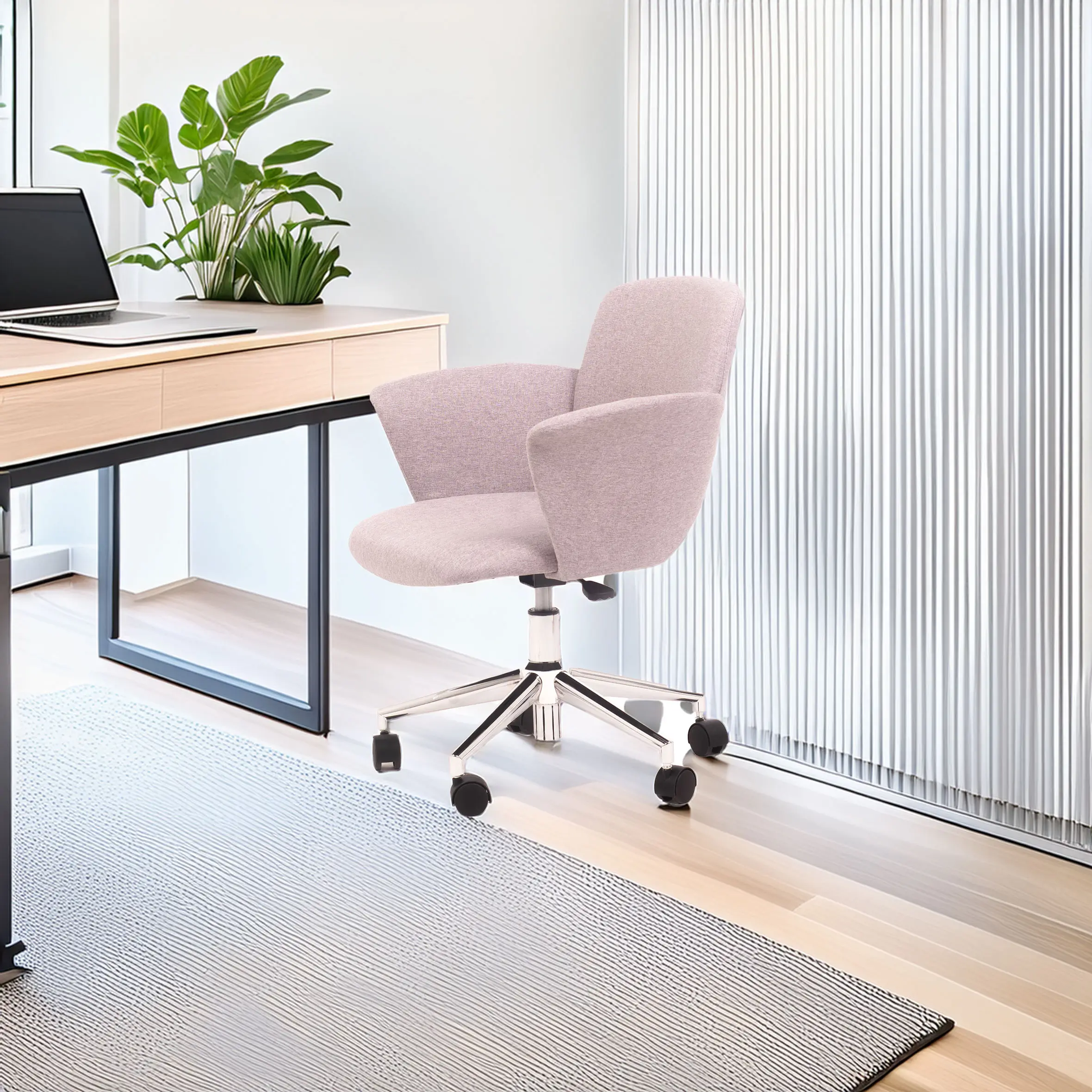 A cozy office chair with grey upholstery sits on a light wood floor near a modern desk with a laptop and green plants, creating a calm workspace vibe