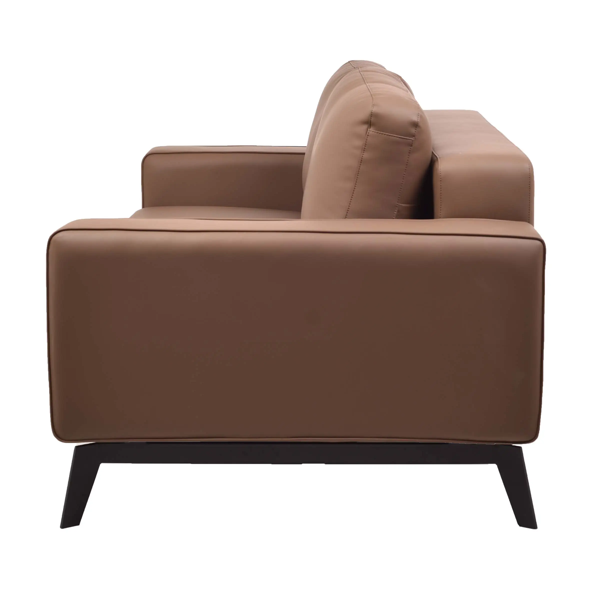 A modern office space with a brown leather sofa on a gray rug. Glass walls reveal desks, plants, and shelves, creating an inviting, professional atmosphere.