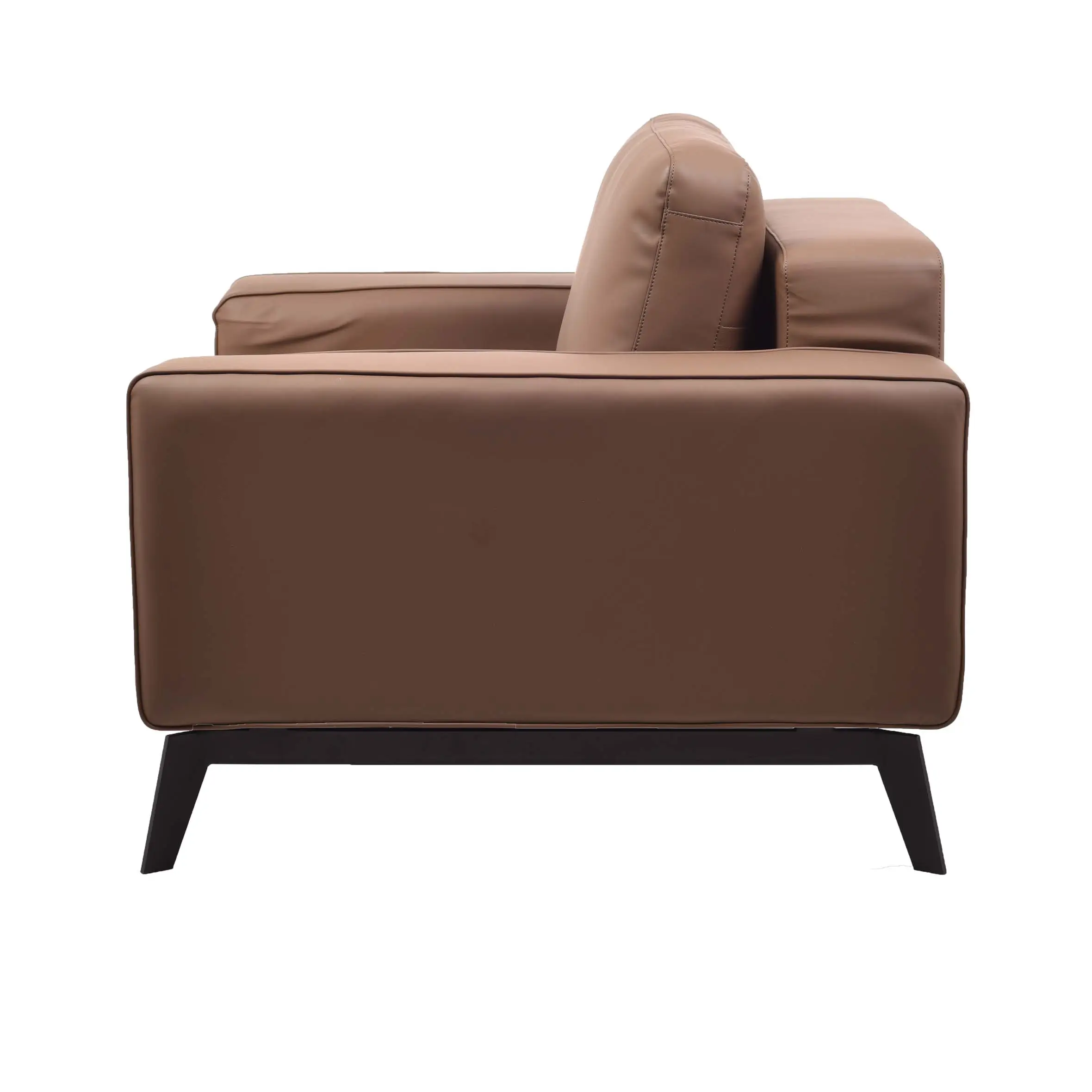 A modern office space with a brown leather sofa on a white rug, wooden floor, glass windows, and a sleek desk with a laptop. A calm, professional ambiance.