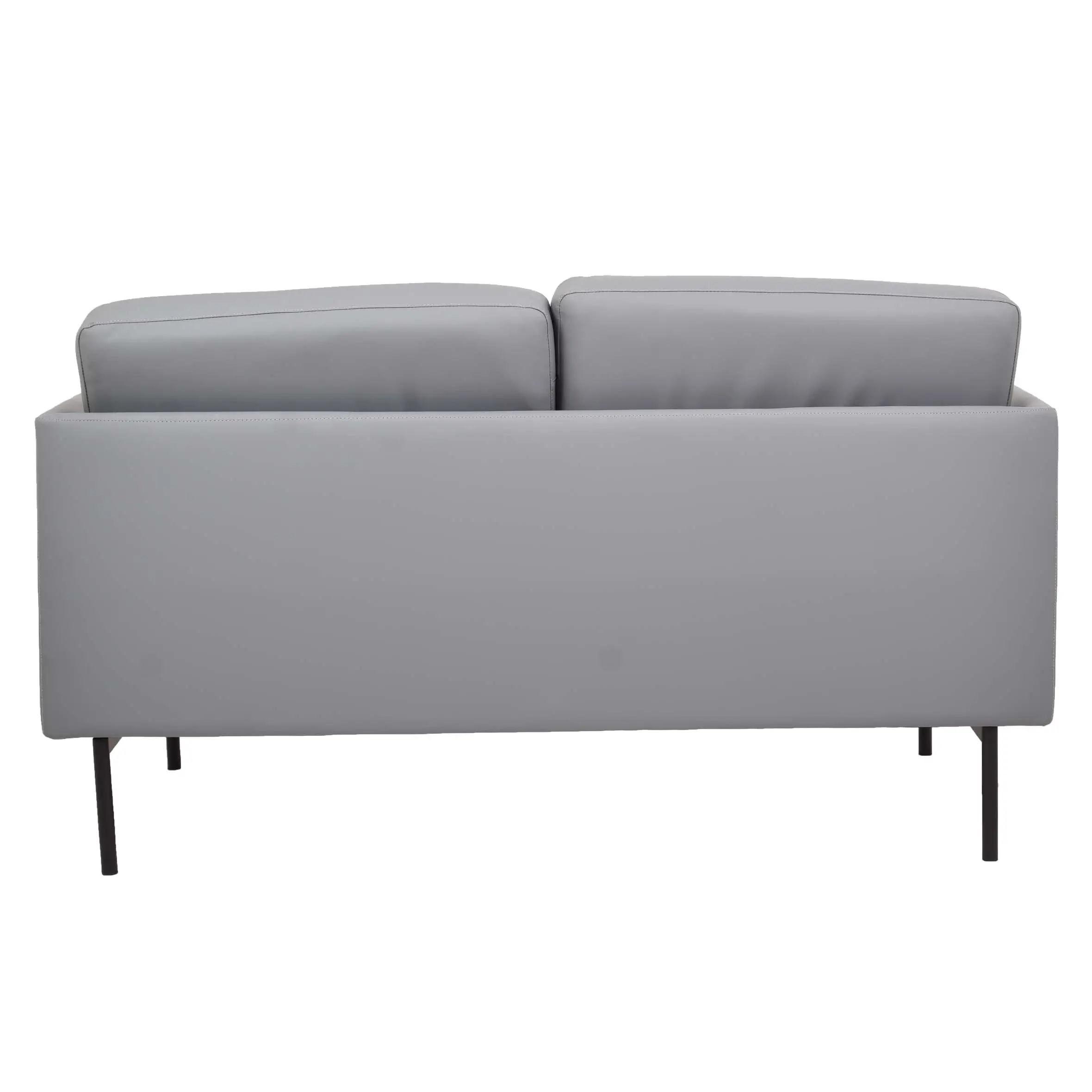 Modern office lounge with a grey sofa and ottoman on a textured rug. Large windows offer a city view, and potted plants add a fresh touch.