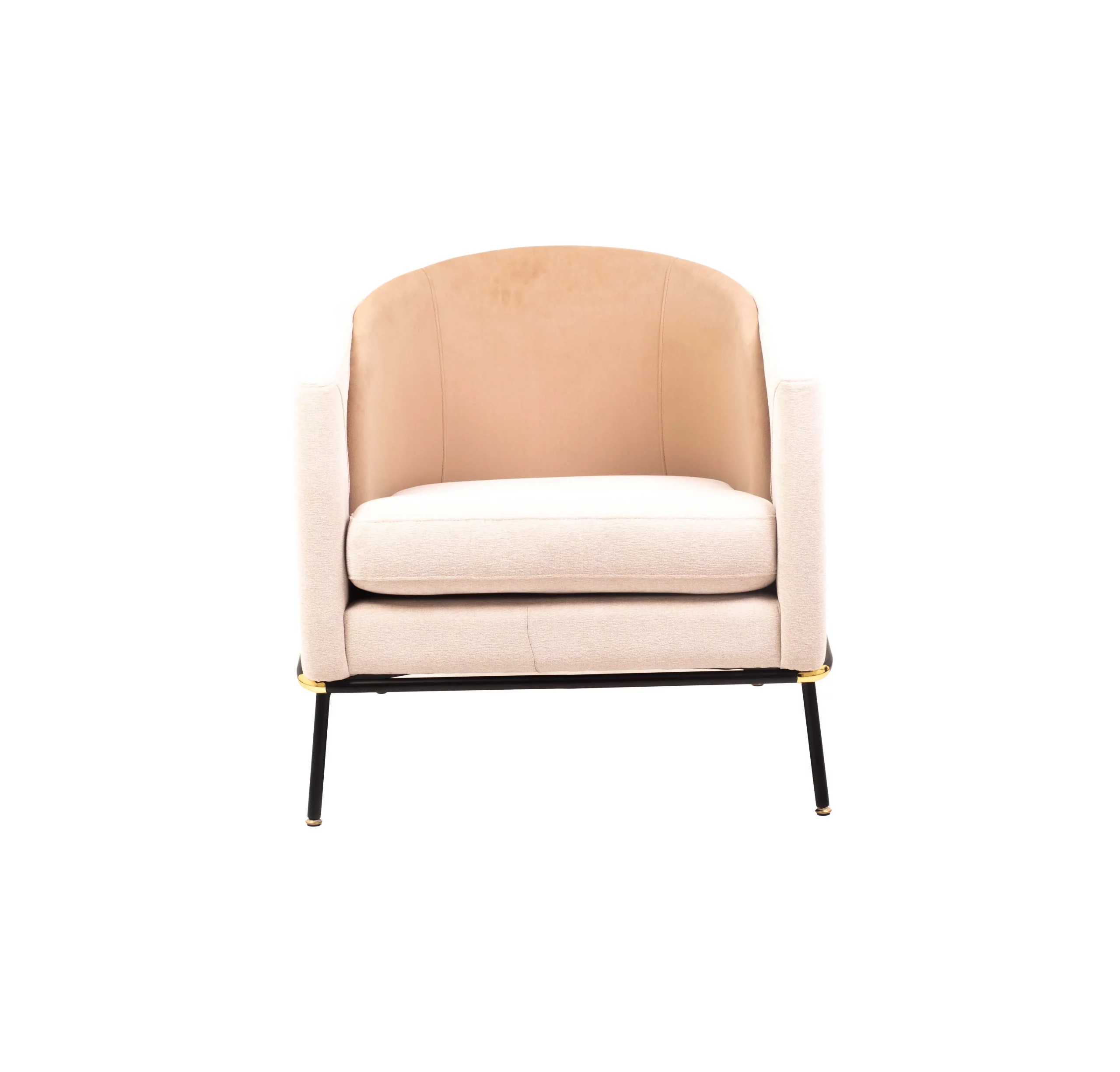 A modern beige armchair with black legs rests on a light gray rug. A round table with stacked magazines and a vase with dried flowers is beside it.