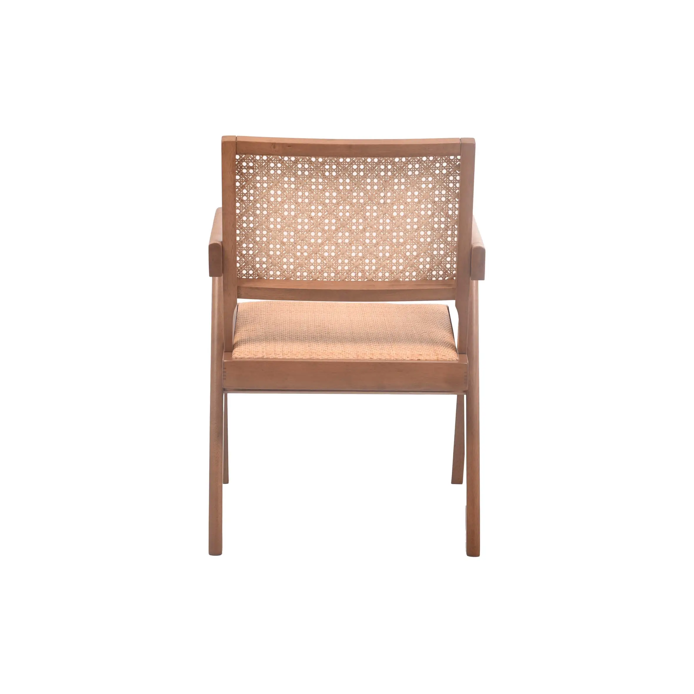 A minimalist room features a wooden chair with woven rattan details beside large windows. Nearby, a lush potted plant adds greenery. The space feels serene.