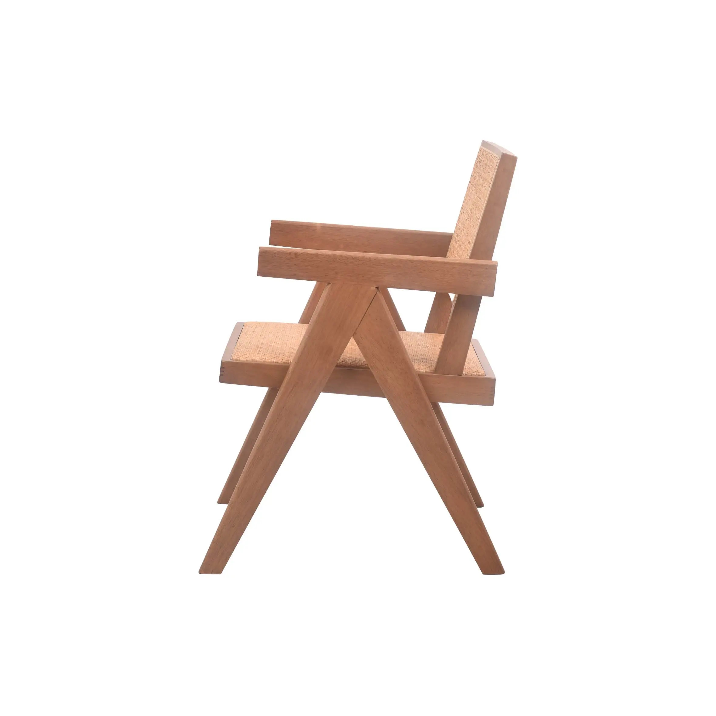 A minimalist room features a wooden chair with woven rattan details beside large windows. Nearby, a lush potted plant adds greenery. The space feels serene.