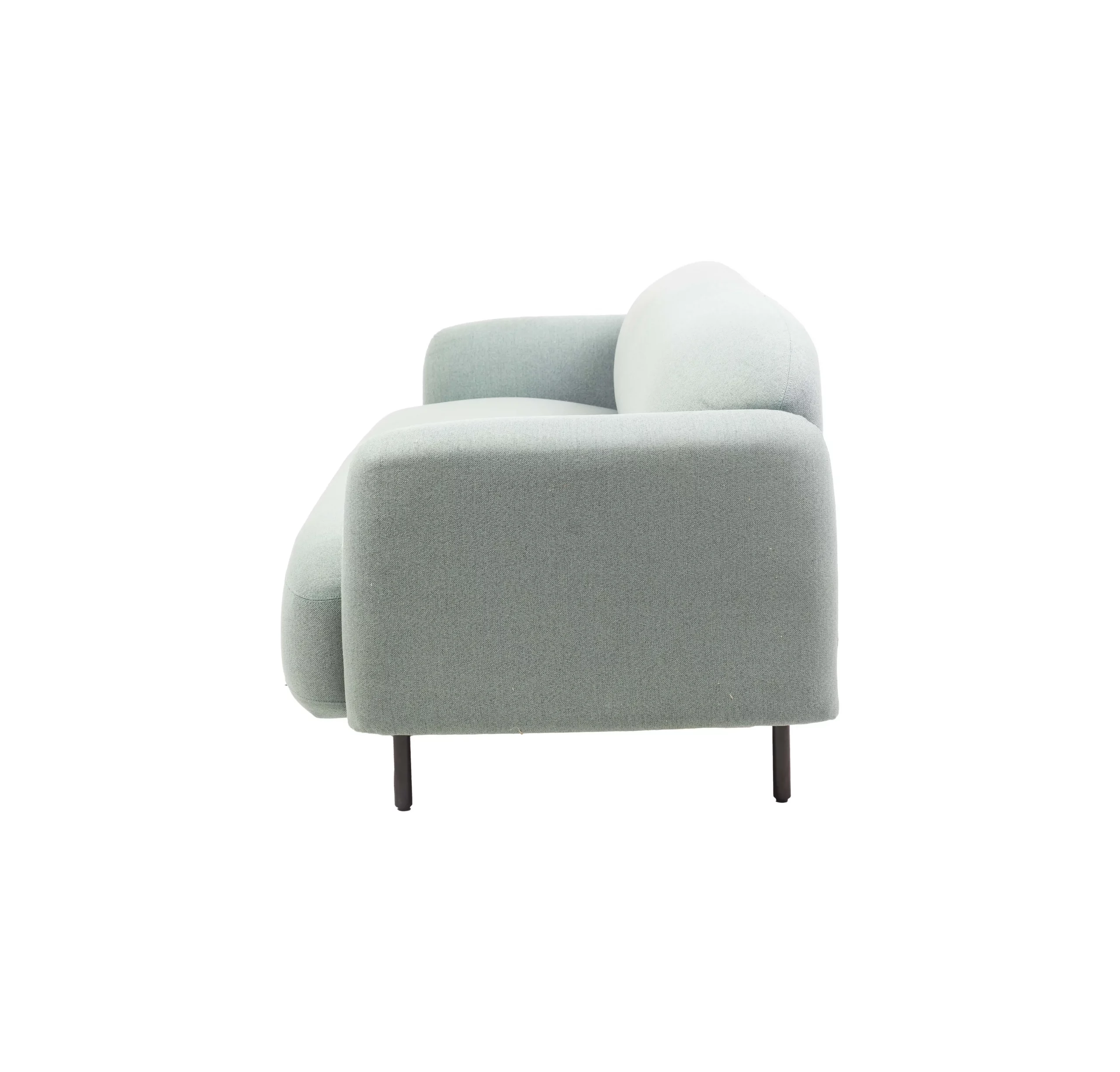 Mint Green sofa in a sleek modern office with large windows, gray rug, plants, and city view. Minimalist and cozy ambiance with a neutral palette.