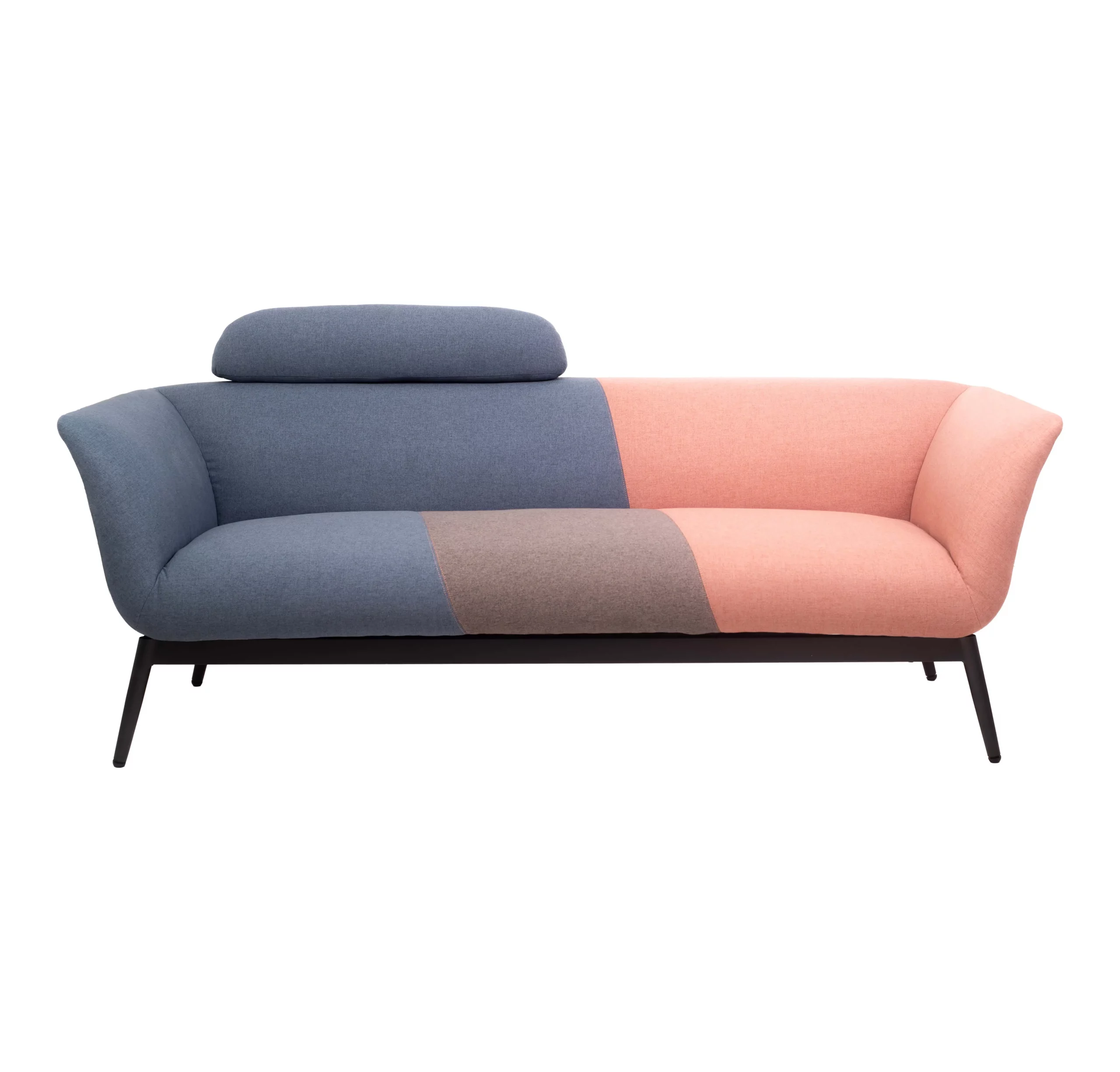 Colorful modern sofa with pink, brown and blue patchwork design. It's set against a minimalist backdrop, flanked by green plants and black pendant lights.