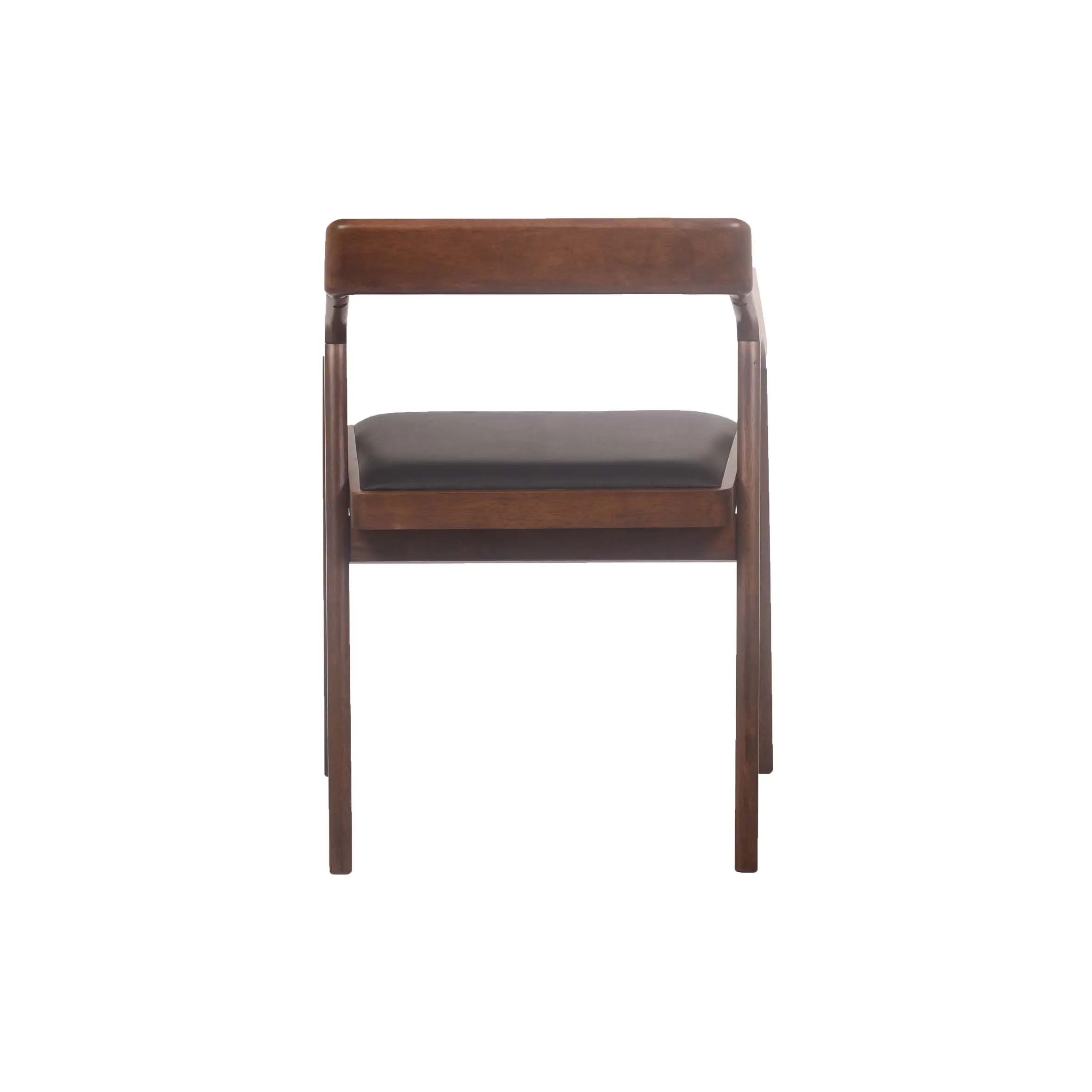 A modern wooden chair with a black cushion sits on polished wooden floors in a bright room, alongside a wooden desk and shelves, evoking a sleek, minimalist design.