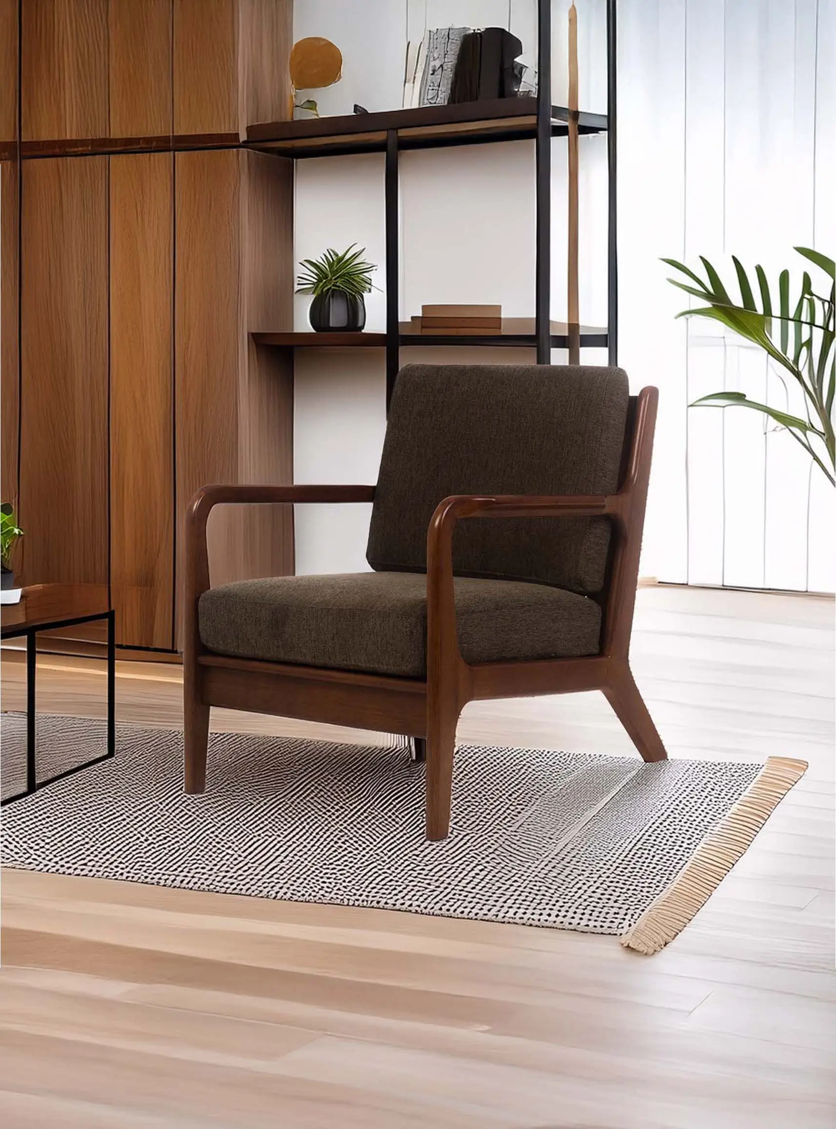Brown wooden armchair with dark cushion sits on a patterned rug. Background includes wooden shelves and a plant, creating a cozy, modern ambiance.