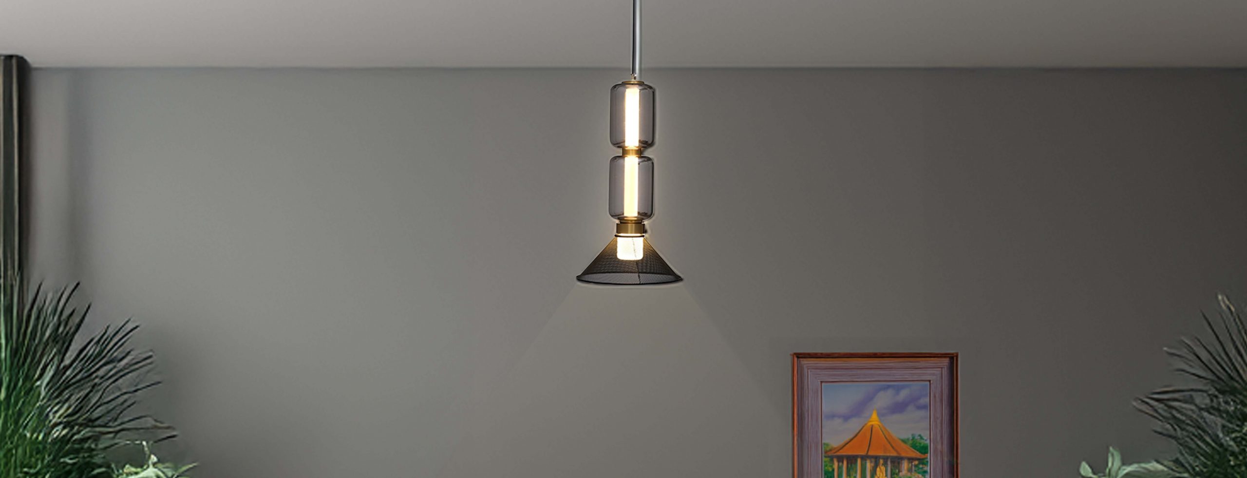 A modern pendant light hangs in a stylish workspace. Nearby, text promotes eco-friendly, elegant bamboo lighting for warmth and inspiration.